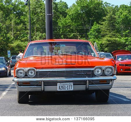 GLOUCESTER VA - MAY 28 2016: A red 1965 Chevrolet Impala SS 396 at the First Aaron's rental car and Motorcycle show the show is Sponsored by Aaron's furniture rental of Gloucester