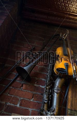 Jazz club instruments hang on brick wall at night