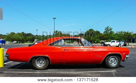 GLOUCESTER VA - MAY 28 2016: A red 1965 Chevrolet Impala SS 396 at the First Aaron's rental car and Motorcycle show the show is Sponsored by Aaron's furniture rental of Gloucester