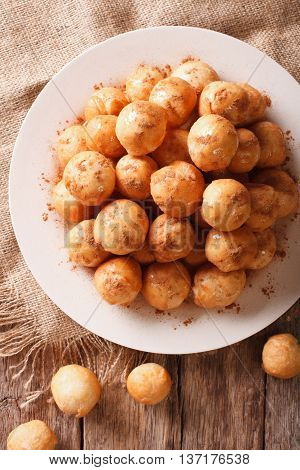 Turkish Lokma Donuts With Honey And Cinnamon Close-up. Vertical Top View