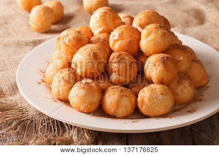 Turkish Lokma Donuts With Honey And Cinnamon Close-up. Horizontal