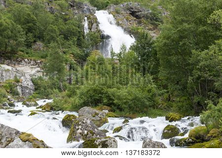 Mountain river from melted ice of Briksdalsbreen glacier at summer. Jostedalsbreen National Park in Norway.