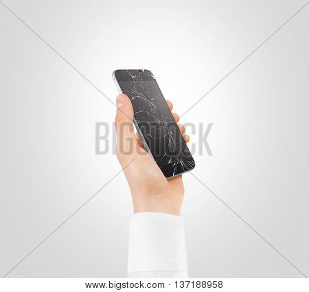 Hand holding broken phone with smashed touch screen, cipping path. Arm hold cracked smartphone, isolated. Smart mobile cellphone display scratch. Telephone monitor problems, need repair.