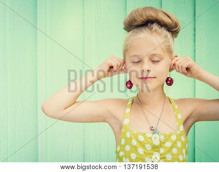 Beautiful girl holding cherries as earrings -style Rockabilly. Space for text