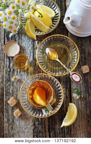 Summer composition: glass of tea with lemon and honey