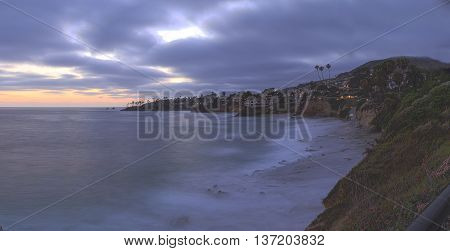 Dark clouds over Diver's Cove in Laguna Beach at sunset in the summer.