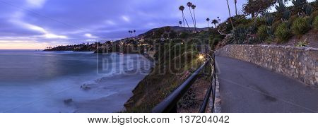 Dark clouds over Diver's Cove in Laguna Beach at sunset in the summer.
