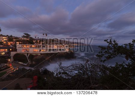 Dark clouds over Diver's Cove in Laguna Beach at sunset in the summer.