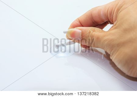 Pull the suction cap from the glass by hand
