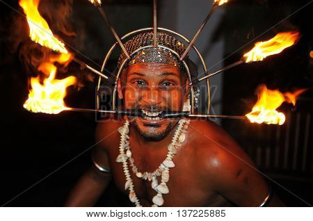 Sri Lanka - 29 November 2013: Fire show. Fakir takes a risky trick with burning torches in Galle, Sri Lanka, 29 November 2013. Editorial.