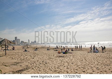 People On Addington Beach Against City Skyline