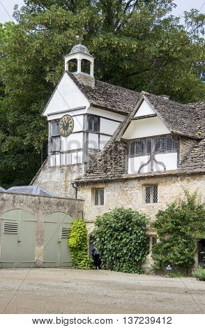 LACOCK ABBEY, LACOCK, WILTSHIRE, UK, 21 JUNE 2016 - View of the clock tower from the courtyard at Lacock Abbey Lacock Wiltsire UK