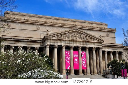 Washington DC - April 11 2014: The classical facade and ornate tympanum bas reliefs of the 1837 Archives of the United States building on Constitution Avenue *