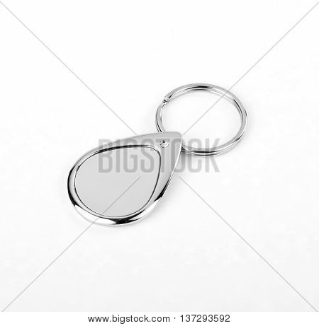 Silver key chain with chain and rings on white background