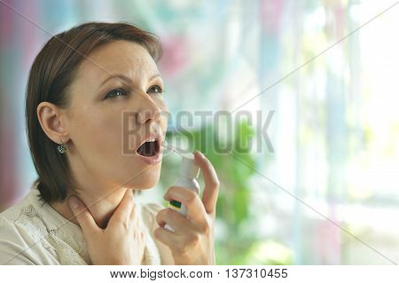 Portrait of a woman squirting throat close up
