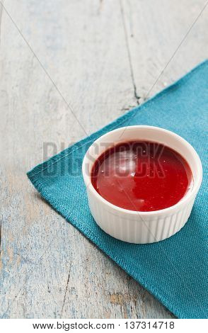 Red Sauce In White On A Blue Background