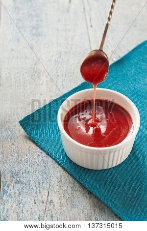 Red Sauce Dripping From A Spoon In The White Form