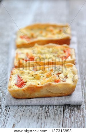 Mini pie with chicken and a tomato