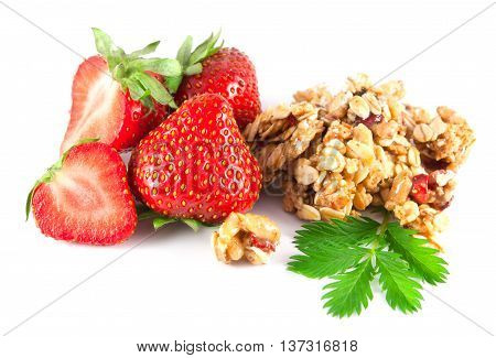 Strawberries with leaves and honey roasted cereal chunks on white background