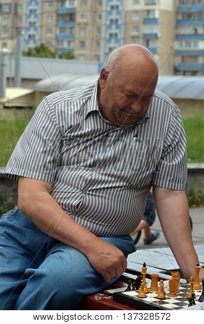 Old men are playing chess in a park, on July 6, 2016 in Kiev, Ukraine