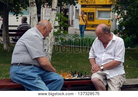 Old men are playing chess in a park, on July 6, 2016 in Kiev, Ukraine