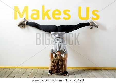Fit woman doing a handstand near the wall below the phrase 
