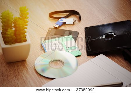 desk with note ,floppy disk A, floppy disk B and memory drive in home office, private office and modern desk in modern life, online market and planning for work, document and paper on desk.