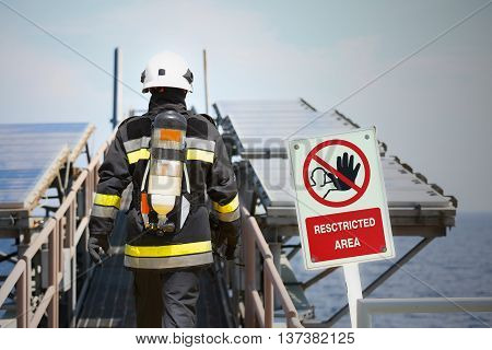 Fire fighter on oil and gas industry, successful firefighter at work , Fire suit for fighter with fire and suit for protect fire fighter, Security team when fire case. restricted area or danger area.