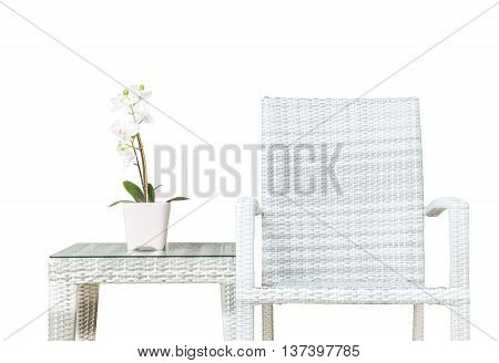 Closeup artificial plant with white orchid flower on pink flower pot on wood weave table with wood weave chair isolated on white background beautiful interior in relaxation concept