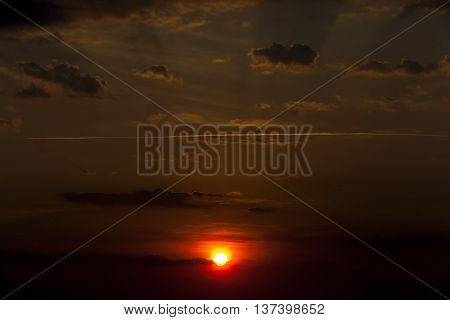 photographed a bright disk of the sun in the sky during sunset