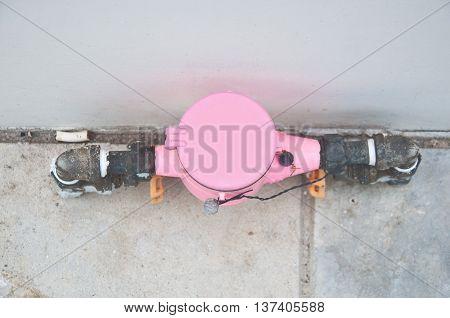 Pink water meter and plumbing in home