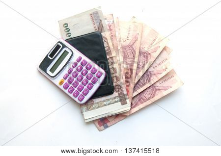 1000 and 100 baht banknotes and calculator isolated on white background