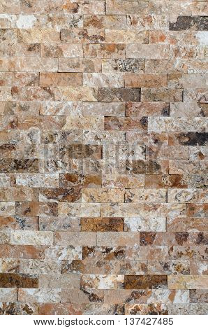 Background of a stone wall cladding texture brown stone bricks