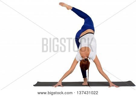 sports exercise isolated on white background. Beautiful woman dressed in sports clothes picks up leg. view from the back