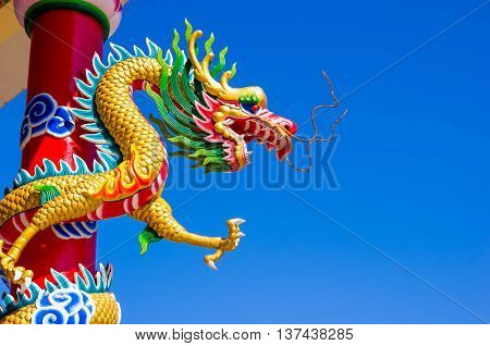 Chinese style dragon statue with blue sky.