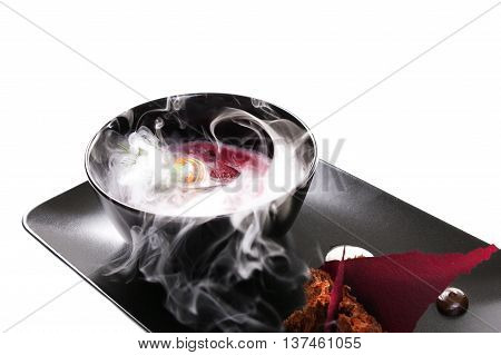 Molecular Cuisine. Delicious modern soup with beetroot. Isolated on white. Stock image.