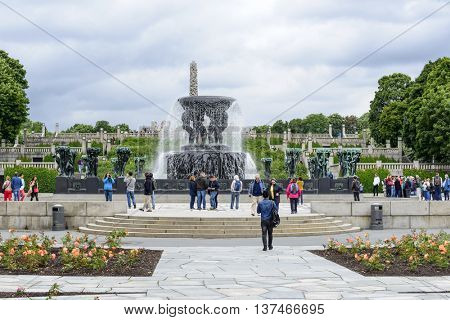 OSLO, NORWAY - JULY 1: Tourists enjoying the beautiful weather visit the Vigeland Sculpture Arrangement in Frogner Park on July 1, 2016 in Oslo, Norway.