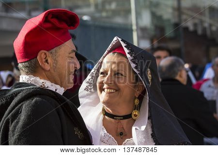 CAGLIARI, ITALY - May 1, 2015: 359 ^ Religious Procession of Sant'Efisio - Sardinia - couple smiling spouses in traditional Sardinian costume