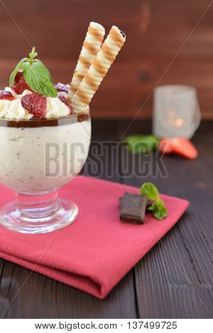 Stracciatella cream with whipped cream, chocolate and strawberries