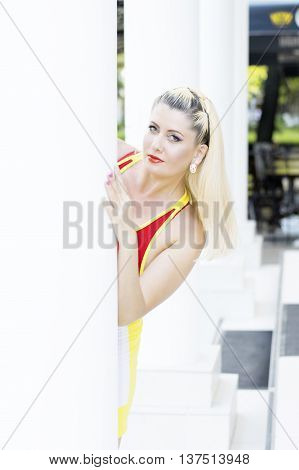 the beautiful woman looks out because of a column at summer restaurant a subject beautiful women