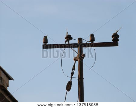 electricity pole on the roof of the house