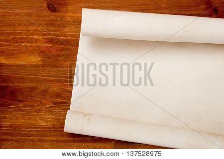 Roll of paper for drawings on a wooden table