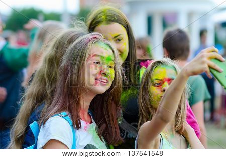 GOMEL BELARUS - JULY 6 2016: Group of teenage girls takes selfie during festival of colors (Holi Festival or ColorFest) in Gomel Belarus