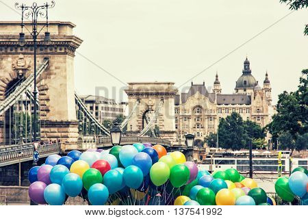 Famous Chain bridge Saint Stephen's basilica and colorful balloons in Budapest Hungary. Cultural heritage. Entertainment event. Travel destination. Retro photo filter. Tourism theme. Architectural theme.