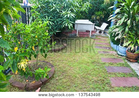 tropica green garden at home - tree and stone table