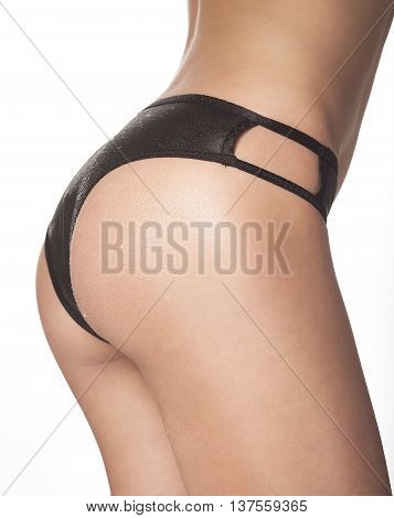 female back in sexy black lingerie on white background.