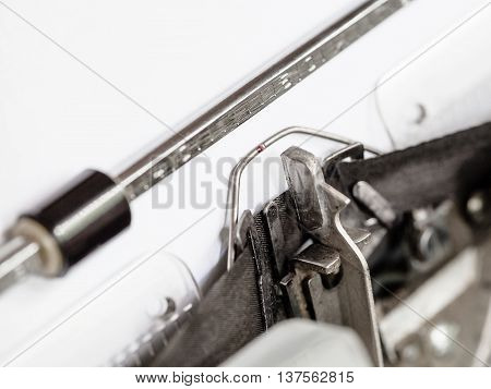 Side View Of Typebar Hits Ink Ribbon In Typewriter