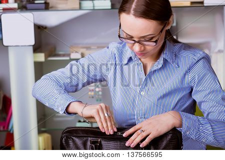 Beautiful Business woman opens a briefcase. Closeup. Business Lifestyle