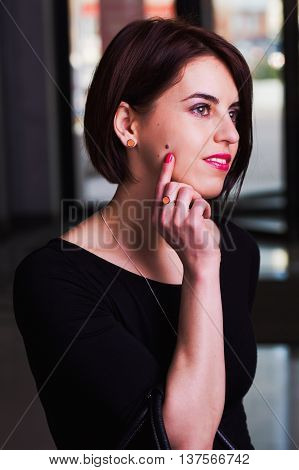 Portrait brunette, stylish,  happy woman in a mall