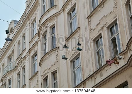 Shoes hung on a rope across the street
